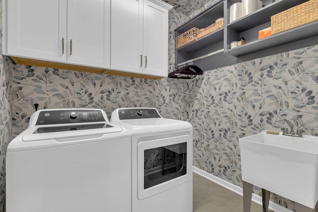 3002 Obion Pass, Spring Hill, TN 37174 - laundry area with wallpapered walls, washing machine and dryer, cabinet space, and tile patterned flooring