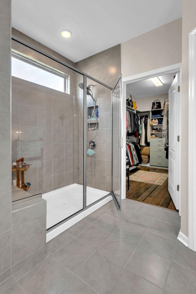 3002 Obion Pass, Spring Hill, TN 37174 - bathroom with a tile shower, a walk in closet, and tile patterned flooring