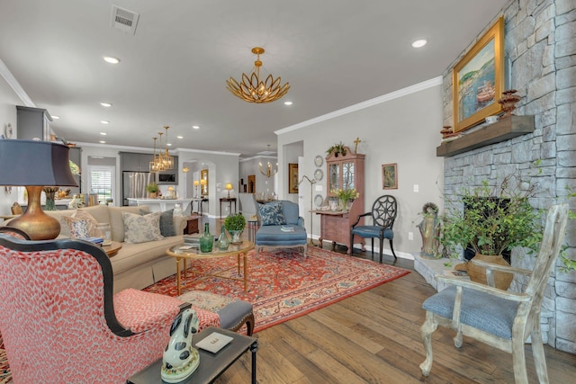 3002 Obion Pass, Spring Hill, TN 37174 - living room with a chandelier, crown molding, wood finished floors, recessed lighting, and a fireplace