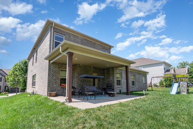 76 Molly Bright Ln, Franklin, TN 37064 - rear view of house featuring brick siding, a patio area, a playground, and a yard