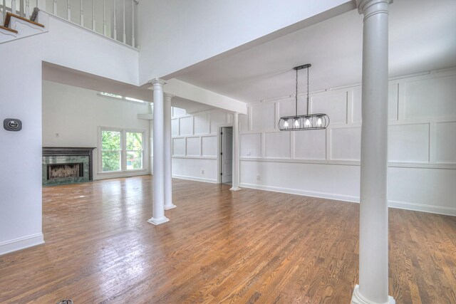 1202 Willow Brook Pass, Mount Juliet, TN 37122 - unfurnished living room with decorative columns, wood finished floors, a high end fireplace, and a decorative wall