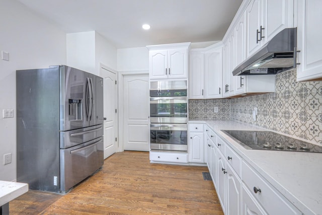 1202 Willow Brook Pass, Mount Juliet, TN 37122 - kitchen featuring appliances with stainless steel finishes, under cabinet range hood, white cabinets, backsplash, and recessed lighting