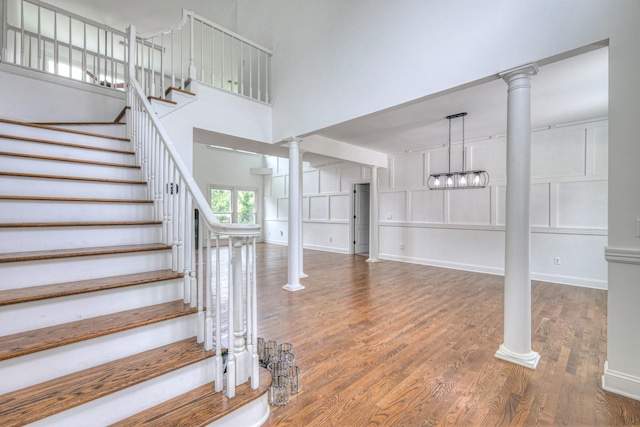 1202 Willow Brook Pass, Mount Juliet, TN 37122 - stairway featuring ornate columns, wood finished floors, and a towering ceiling
