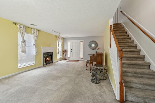 3524 Glenfalls Dr, Hermitage, TN 37076 - living area featuring carpet flooring, stairs, a fireplace with flush hearth, and a textured ceiling