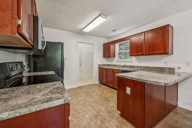 3524 Glenfalls Dr, Hermitage, TN 37076 - kitchen with a peninsula, range with electric stovetop, a textured ceiling, reddish brown cabinets, and stainless steel microwave