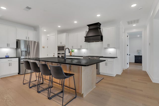 5509 Bridgemore Blvd, Murfreesboro, TN 37129 - kitchen with appliances with stainless steel finishes, custom range hood, decorative backsplash, light wood-style flooring, and recessed lighting
