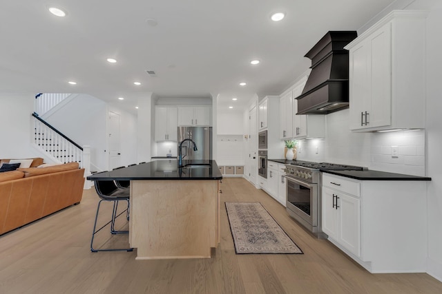 5509 Bridgemore Blvd, Murfreesboro, TN 37129 - kitchen featuring appliances with stainless steel finishes, premium range hood, dark countertops, open floor plan, and recessed lighting