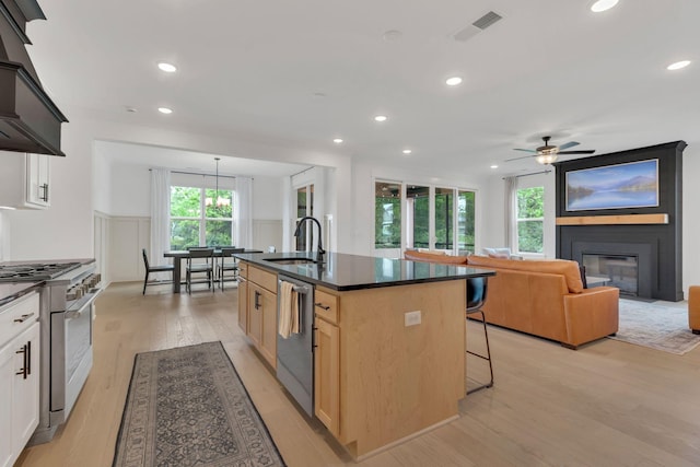 5509 Bridgemore Blvd, Murfreesboro, TN 37129 - kitchen with appliances with stainless steel finishes, dark countertops, premium range hood, light wood-style floors, and a kitchen bar