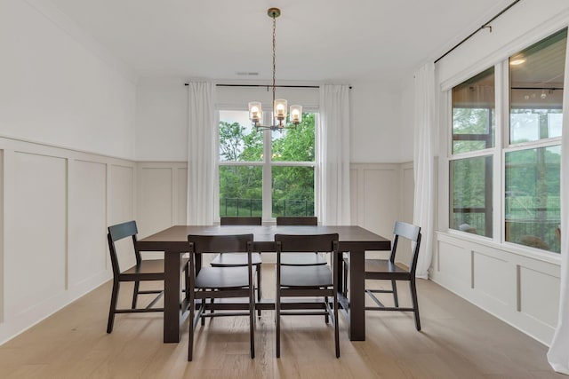 5509 Bridgemore Blvd, Murfreesboro, TN 37129 - dining space featuring a decorative wall, plenty of natural light, a chandelier, wainscoting, and light wood-style flooring