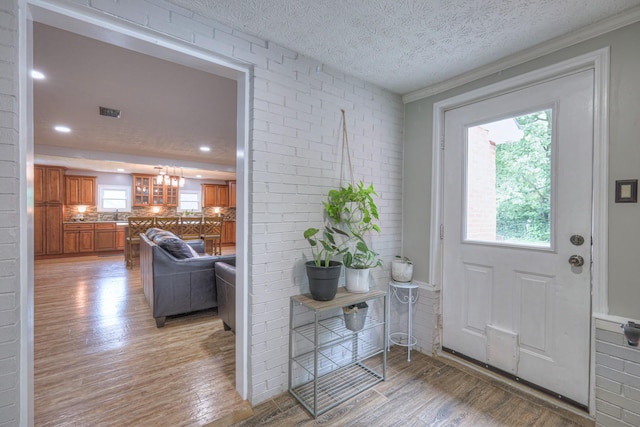 9649 Coles Ferry Pike, Lebanon, TN 37087 - foyer with light wood-type flooring, healthy amount of natural light, a chandelier, brick wall, and recessed lighting