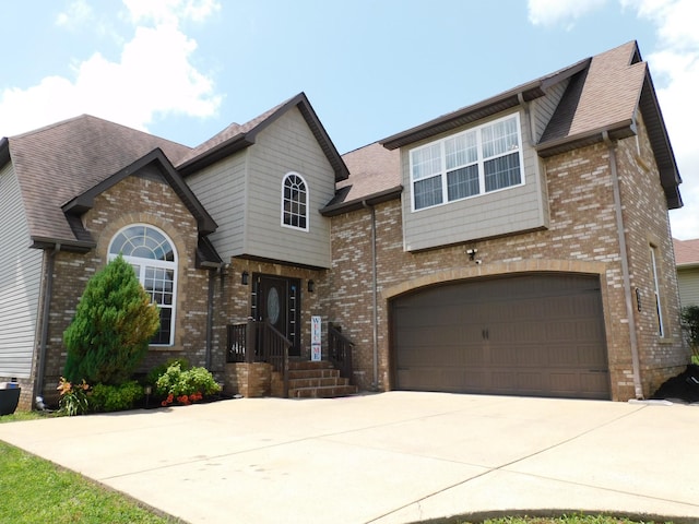 1590 Cobra Ln, Clarksville, TN 37042 - view of front facade featuring brick siding, a garage, driveway, and a shingled roof