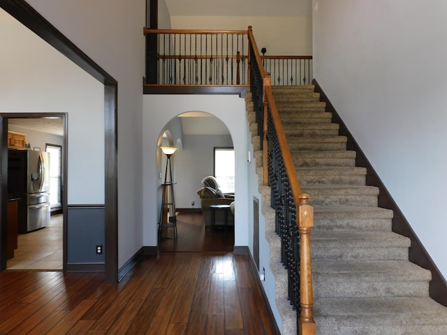 1590 Cobra Ln, Clarksville, TN 37042 - stairway featuring arched walkways, hardwood / wood-style floors, and a high ceiling