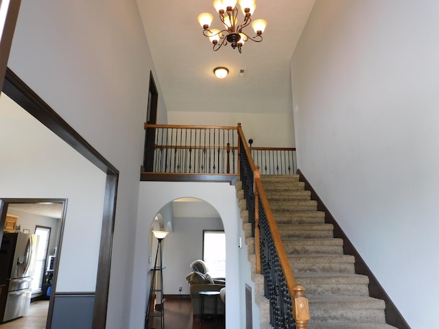 1590 Cobra Ln, Clarksville, TN 37042 - stairs with high vaulted ceiling, arched walkways, and a chandelier
