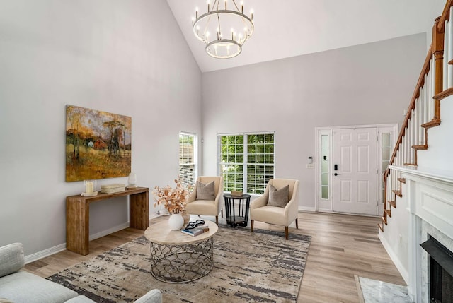 77 Kendall Park Dr, Nashville, TN 37217 - living area featuring high vaulted ceiling, wood finished floors, a chandelier, stairs, and a premium fireplace