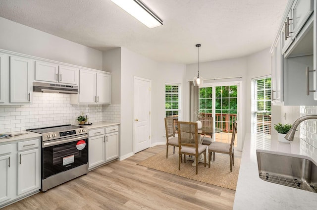 77 Kendall Park Dr, Nashville, TN 37217 - kitchen with electric range, under cabinet range hood, backsplash, light countertops, and a textured ceiling