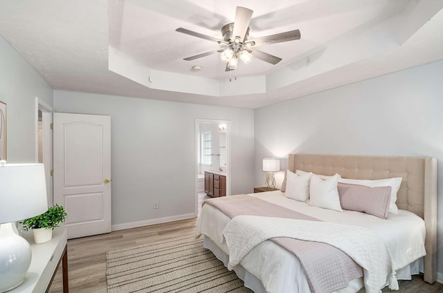 77 Kendall Park Dr, Nashville, TN 37217 - bedroom featuring a raised ceiling, light wood finished floors, ensuite bathroom, and ceiling fan