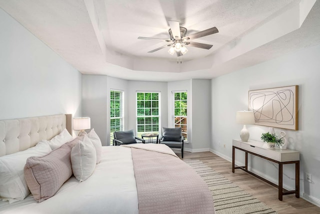 77 Kendall Park Dr, Nashville, TN 37217 - bedroom with light wood-type flooring, a raised ceiling, ceiling fan, and a textured ceiling