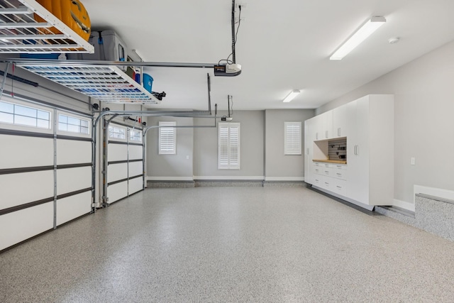 1120 Pretender Way, Columbia, TN 38401 - garage featuring a garage door opener and baseboards