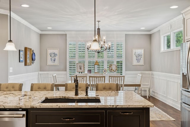 1120 Pretender Way, Columbia, TN 38401 - kitchen featuring appliances with stainless steel finishes, a chandelier, a decorative wall, ornamental molding, and dark wood-style flooring
