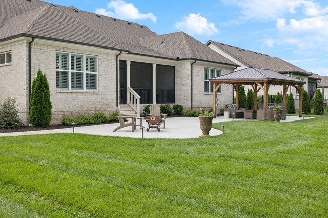 1120 Pretender Way, Columbia, TN 38401 - rear view of property featuring brick siding, a patio, an outdoor living space with a fire pit, and a gazebo