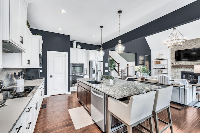 1229 Bobwhite Trl, Nolensville, TN 37135 - kitchen featuring stainless steel appliances, dark wood-type flooring, tasteful backsplash, a breakfast bar, and open floor plan