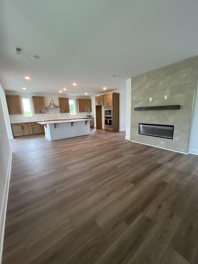 1559 Oak Springs Dr, Columbia, TN 38401 - unfurnished living room featuring dark wood-style floors, recessed lighting, and a tile fireplace
