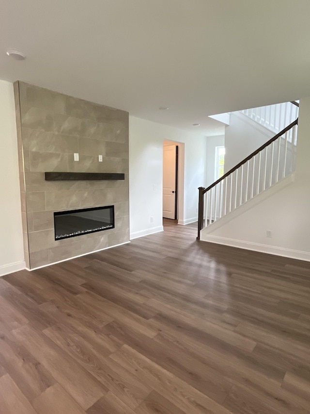 1559 Oak Springs Dr, Columbia, TN 38401 - unfurnished living room with wood finished floors, a fireplace, and stairway