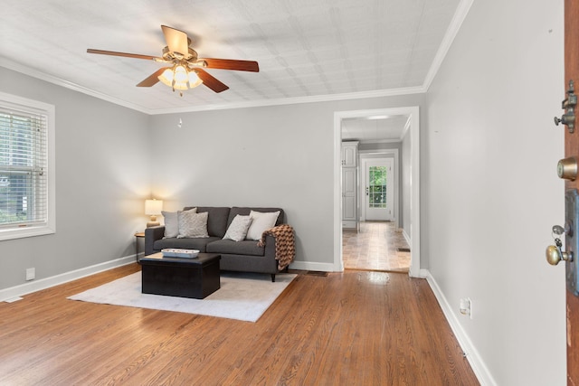 104 S Charlotte St, Dickson, TN 37055 - living room featuring wood finished floors, ceiling fan, and ornamental molding