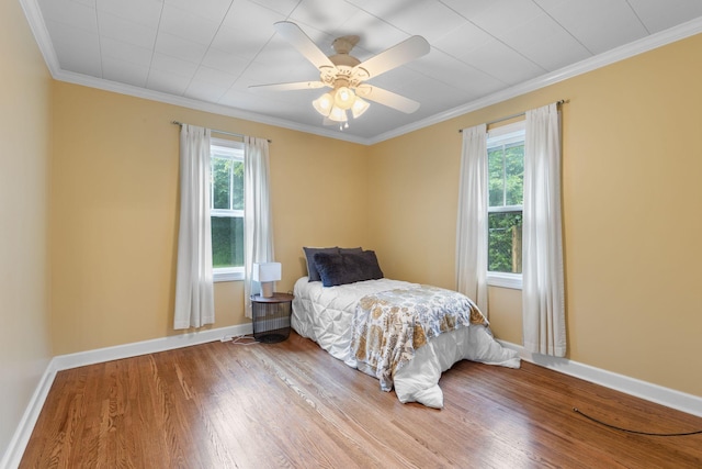 104 S Charlotte St, Dickson, TN 37055 - bedroom with multiple windows, wood finished floors, crown molding, and a ceiling fan