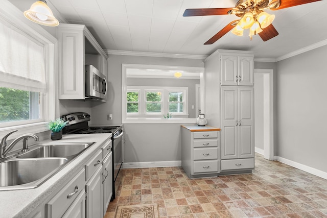 104 S Charlotte St, Dickson, TN 37055 - kitchen featuring appliances with stainless steel finishes, light countertops, light stone finish floors, white cabinets, and ceiling fan