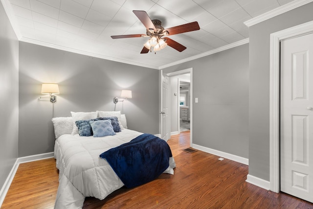 104 S Charlotte St, Dickson, TN 37055 - bedroom with ornamental molding, wood finished floors, and a ceiling fan