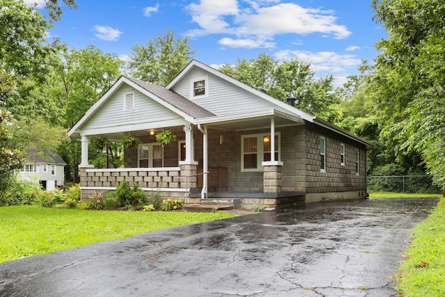 104 S Charlotte St, Dickson, TN 37055 - view of front of home with a porch, driveway, and a front lawn