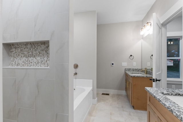 4100 Asbury Rd, Manchester, TN 37355 - bathroom featuring vanity, a tub to relax in, and marble look tiles