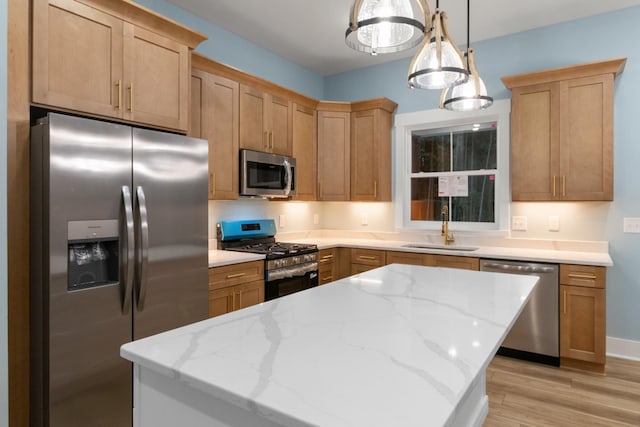 4100 Asbury Rd, Manchester, TN 37355 - kitchen featuring stainless steel appliances, light wood-type flooring, a kitchen island, and light stone countertops