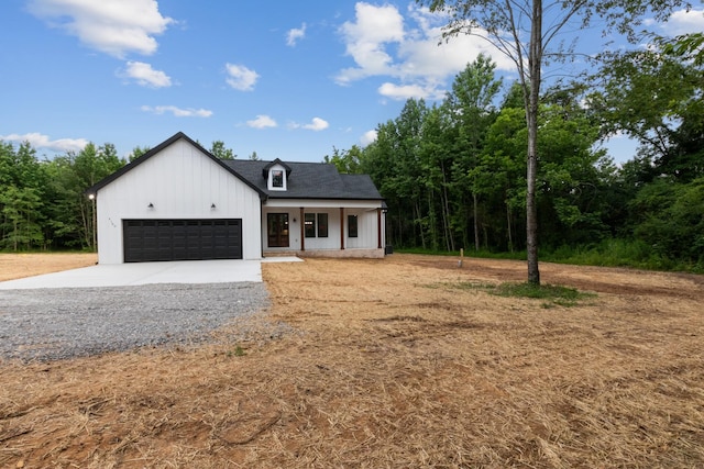 4100 Asbury Rd, Manchester, TN 37355 - modern farmhouse style home with concrete driveway, an attached garage, a porch, and board and batten siding