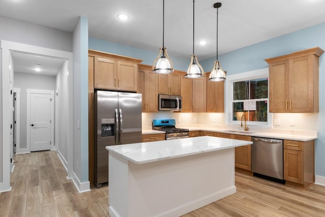 4100 Asbury Rd, Manchester, TN 37355 - kitchen featuring appliances with stainless steel finishes, light wood-type flooring, a kitchen island, decorative light fixtures, and recessed lighting