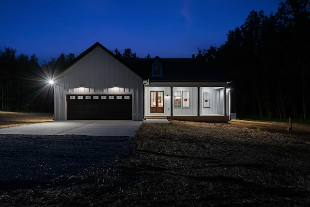 4100 Asbury Rd, Manchester, TN 37355 - modern farmhouse style home with board and batten siding, driveway, an attached garage, and french doors