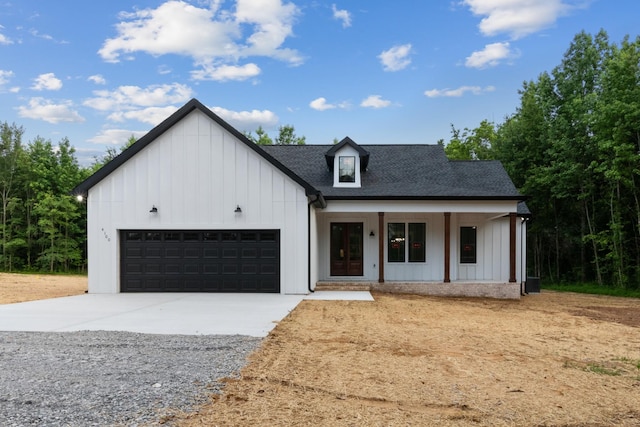 4100 Asbury Rd, Manchester, TN 37355 - modern farmhouse featuring board and batten siding, driveway, an attached garage, covered porch, and a shingled roof