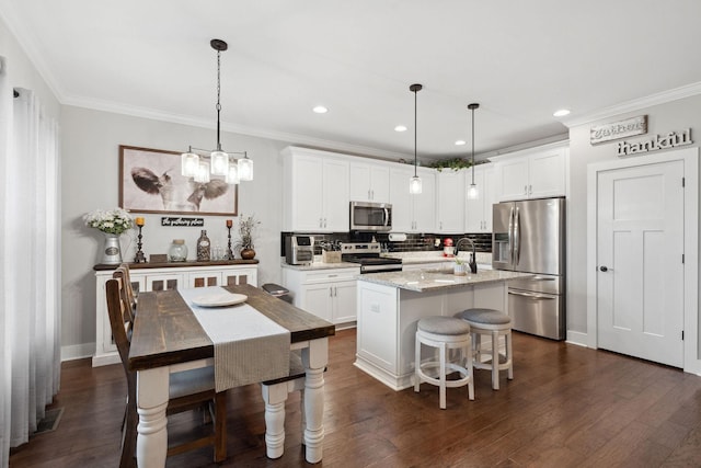 4731 Lunns Store Rd, Chapel Hill, TN 37034 - kitchen with stainless steel appliances, crown molding, tasteful backsplash, an island with sink, and white cabinetry