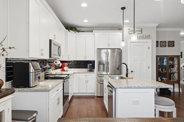 4731 Lunns Store Rd, Chapel Hill, TN 37034 - kitchen featuring appliances with stainless steel finishes, crown molding, dark wood-type flooring, tasteful backsplash, and a kitchen island with sink