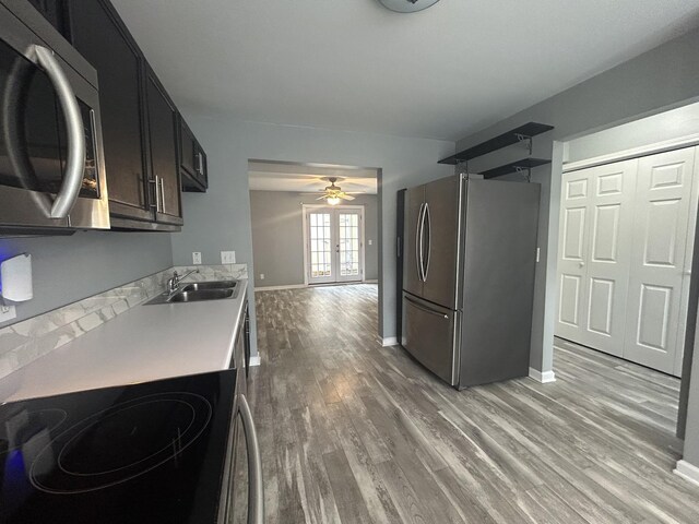7206 Rosemary Ct, Fairview, TN 37062 - kitchen with stainless steel appliances, light countertops, light wood-type flooring, and ceiling fan