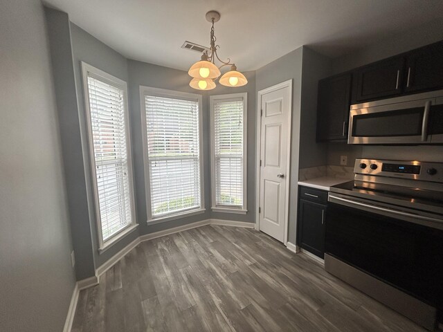 7206 Rosemary Ct, Fairview, TN 37062 - kitchen with appliances with stainless steel finishes, dark cabinetry, wood finished floors, and light countertops