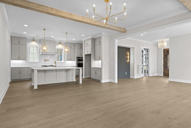8011 Cane Creek Rd, Nashville, TN 37221 - unfurnished living room with a chandelier, ornamental molding, recessed lighting, and light wood-style flooring