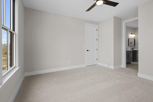 8011 Cane Creek Rd, Nashville, TN 37221 - unfurnished bedroom featuring light carpet, connected bathroom, and ceiling fan
