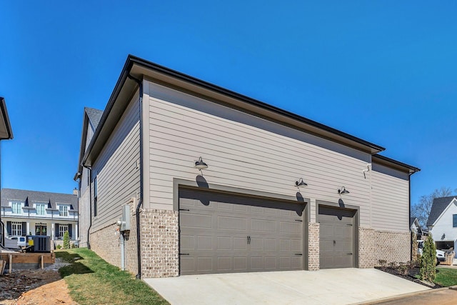 8011 Cane Creek Rd, Nashville, TN 37221 - view of home's exterior featuring brick siding, concrete driveway, and an attached garage