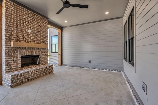 8011 Cane Creek Rd, Nashville, TN 37221 - unfurnished living room with ceiling fan, tile patterned flooring, an outdoor brick fireplace, wood walls, and recessed lighting