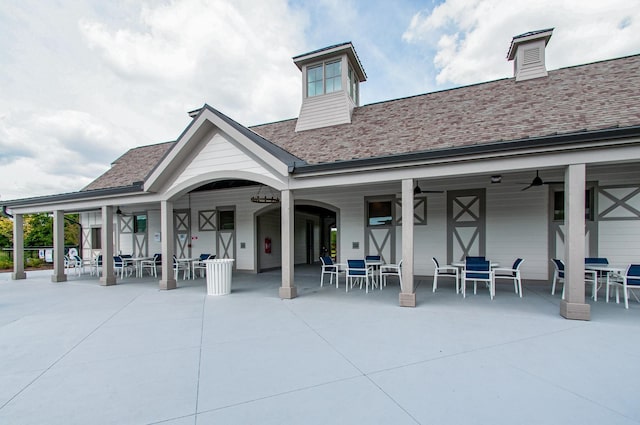 8011 Cane Creek Rd, Nashville, TN 37221 - back of property with outdoor dining space, ceiling fan, and roof with shingles