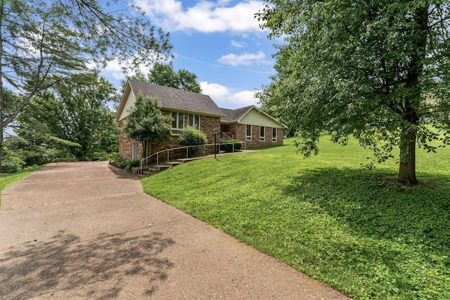 123 Proffitt St, Carthage, TN 37030 - view of front facade featuring brick siding, a front yard, and a shingled roof
