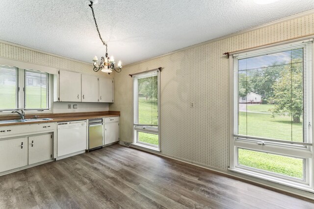 123 Proffitt St, Carthage, TN 37030 - kitchen with white dishwasher, a chandelier, a textured ceiling, wallpapered walls, and dark wood-style flooring