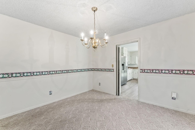123 Proffitt St, Carthage, TN 37030 - empty room featuring a chandelier, light colored carpet, and a textured ceiling